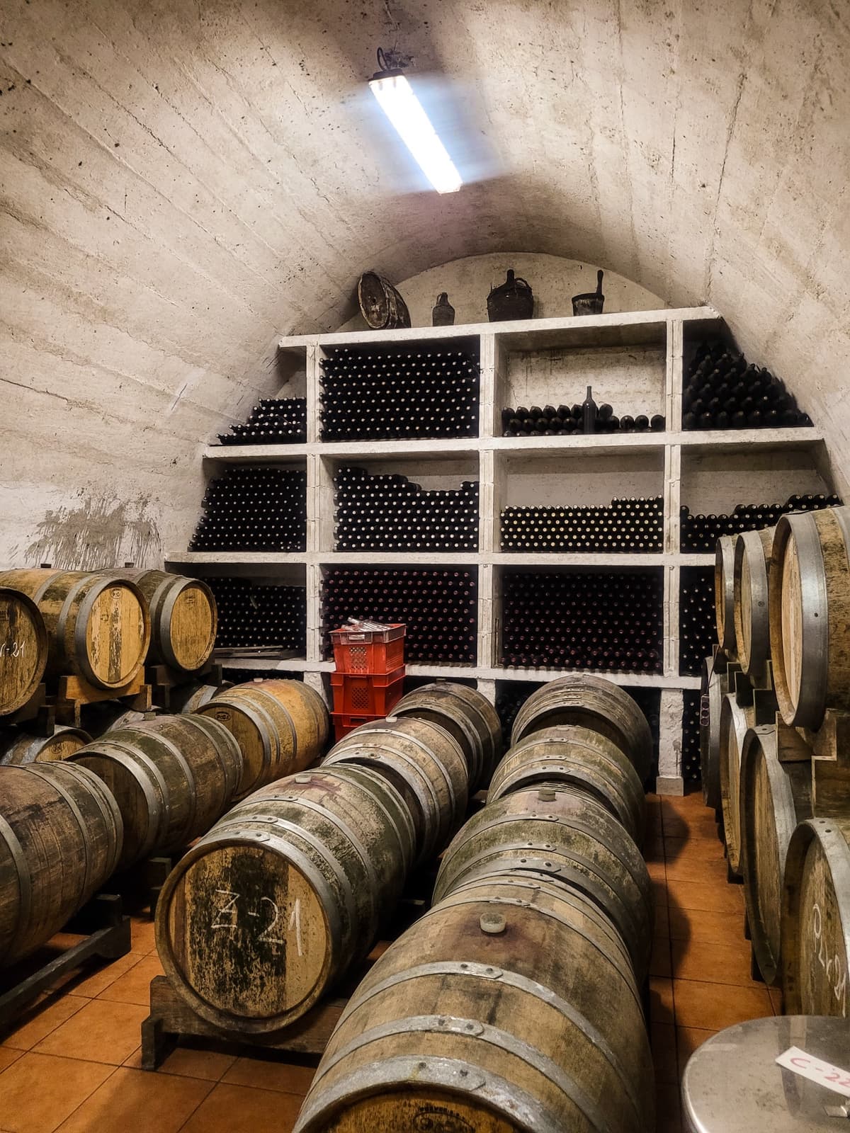 Lipanovic winery wine barrels stored in a converted army tunnel on Vis island, a Croatia workation wine tasting.
