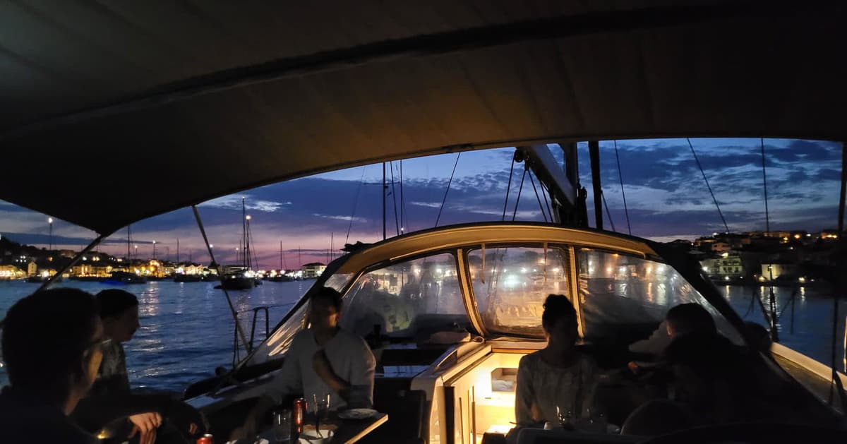 Driftawave team gathered on the yacht cockpit at sunset in a Croatian marina during a sailing workation.