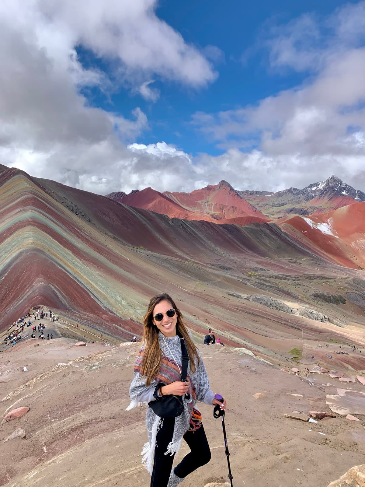 Kristin Vierra hiking Rainbow Mountain in Peru, embracing the digital nomad lifestyle.