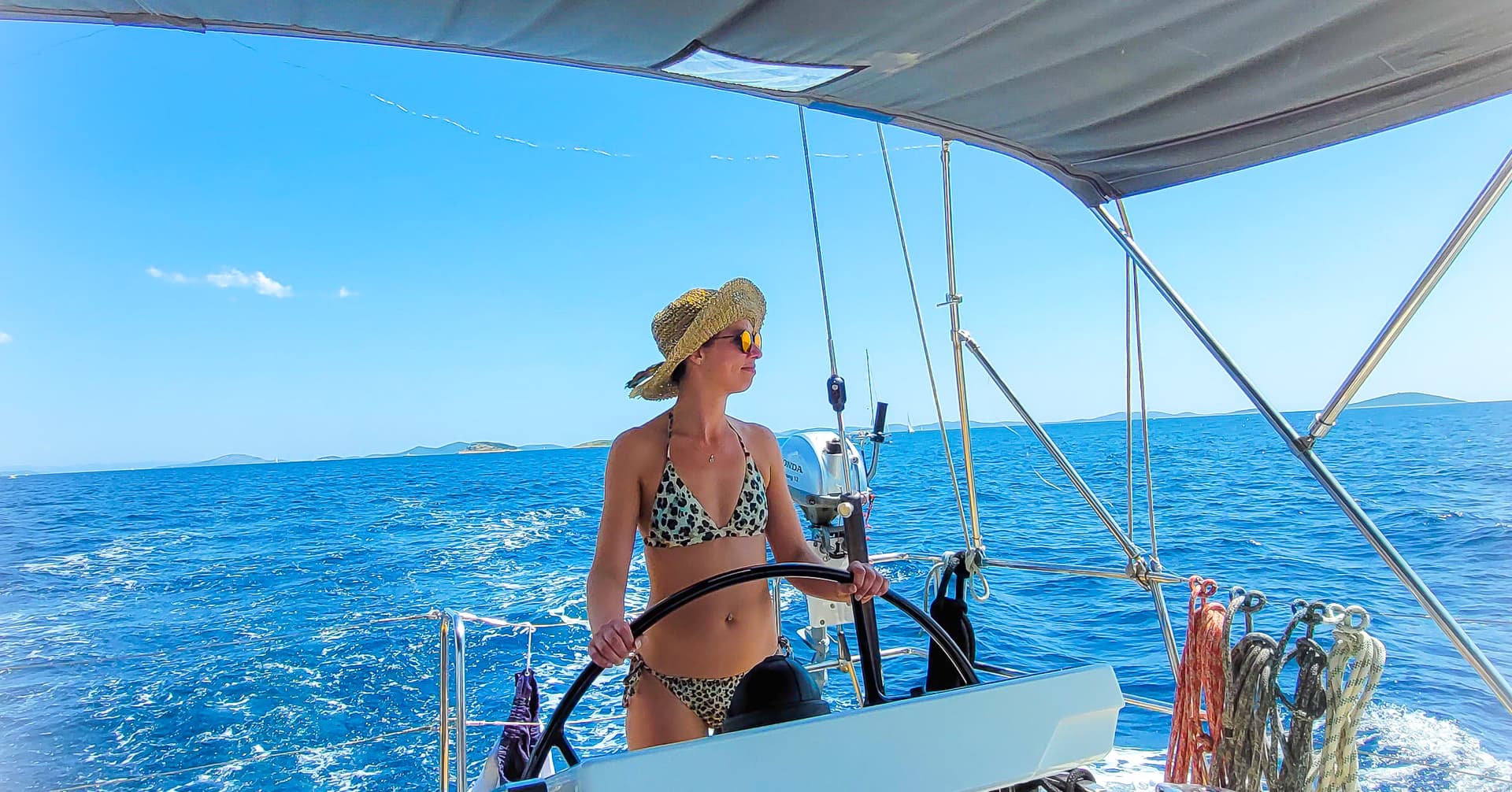 Founder enjoying a well deserved sailing workation in Croatia, at the helm of a yacht on the Adriatic coast.