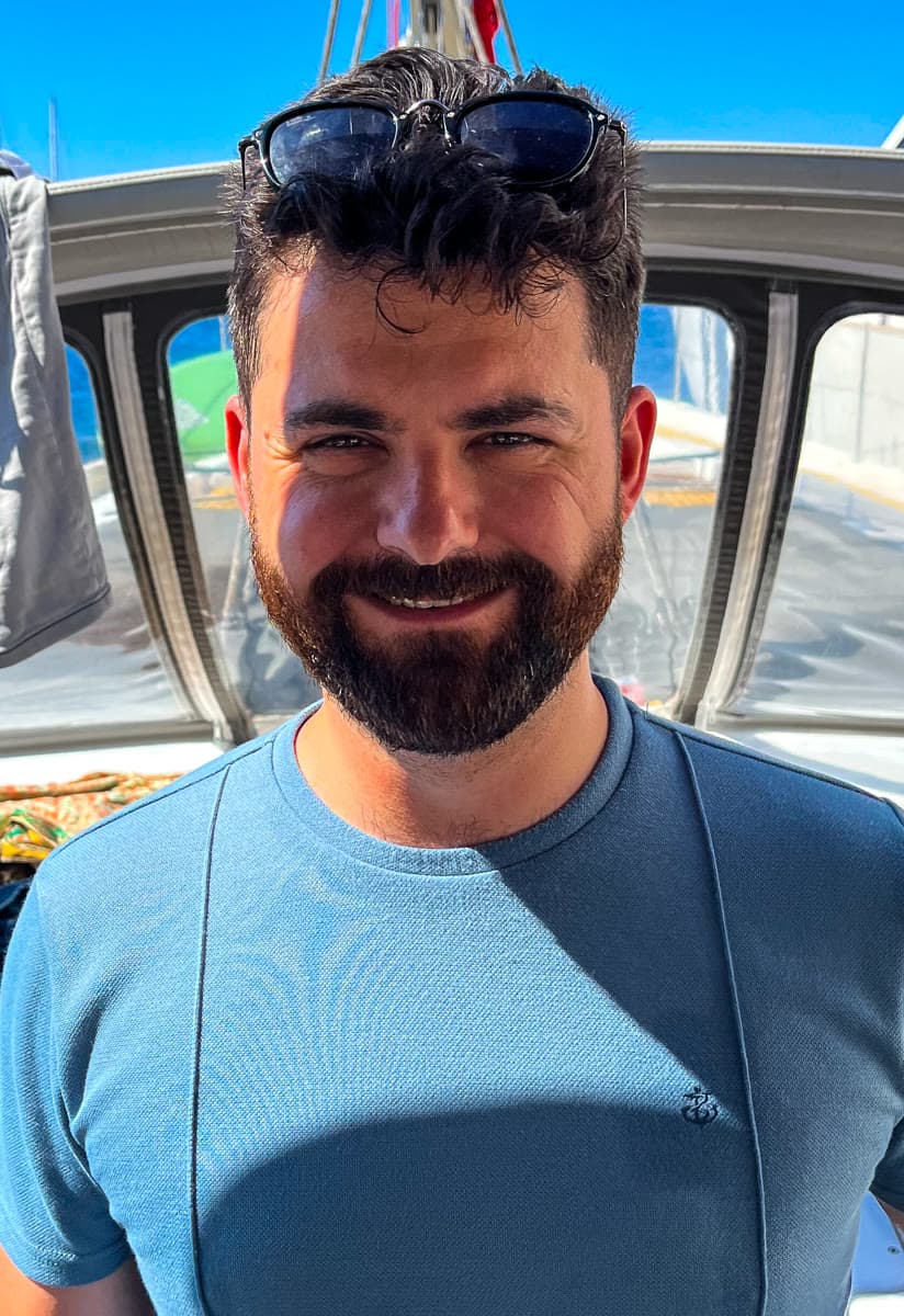 Elia Argentiero smiling on a sailing yacht on the Adriatic Sea during a Driftawave workation in Croatia.