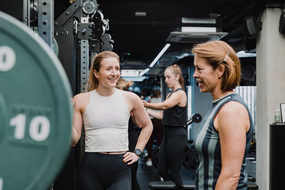 Emily Taylor coaching a client through a strength session at HumanOS