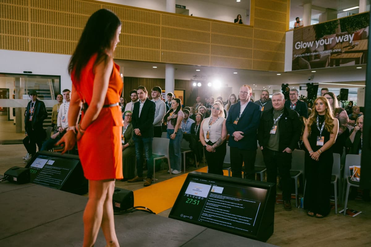A room of colleagues standing up during a stay-standing-if exercise at a HumanOS session