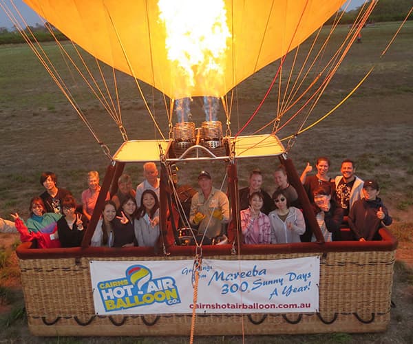 A full team lifting off in a hot air balloon over Australia, sunrise on an adventure company offsite