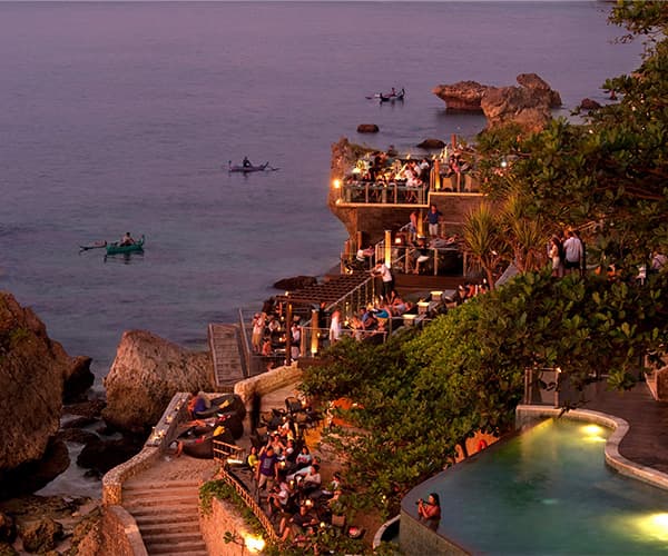 Company offsite celebration at sunset cliffside venue with ocean views in Bali