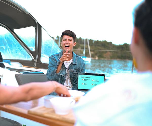 Team laughing during ocean sustainability workshop aboard yacht on Adriatic Sea Croatia