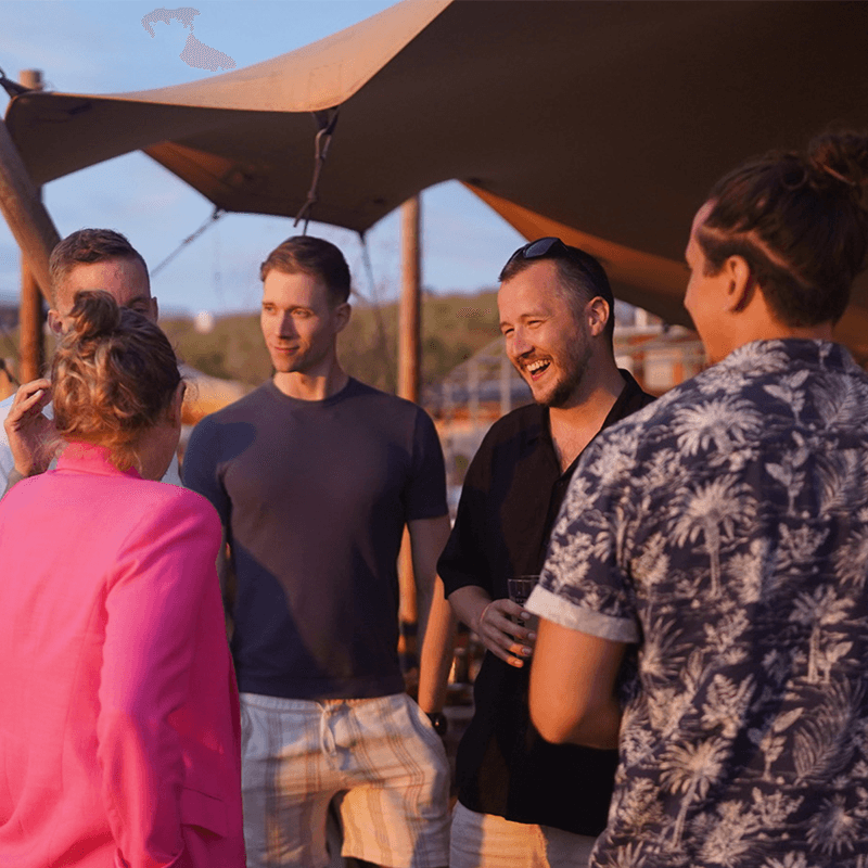 An innovation team talking it through under the safari tent, working session on a company offsite