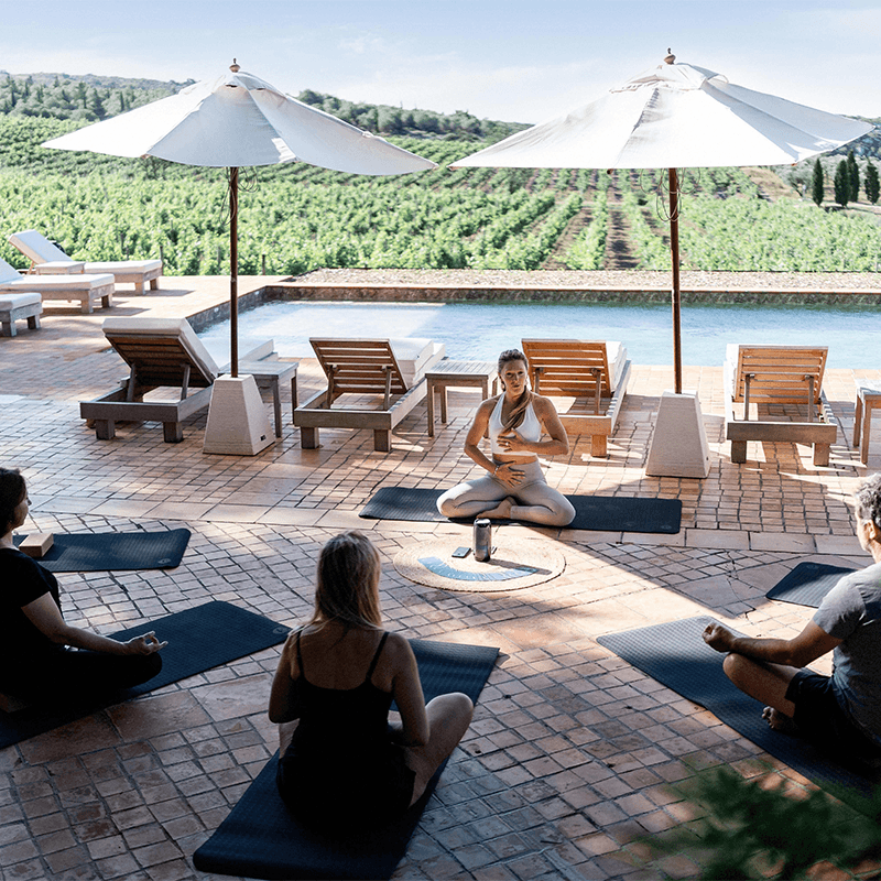 A yoga session by the vineyard pool in France, the slow half of a team retreat day
