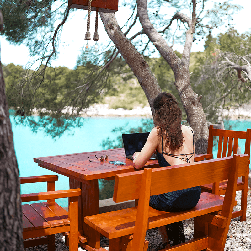 Remote team member planning innovation strategy during workation retreat in Croatia overlooking Adriatic Sea