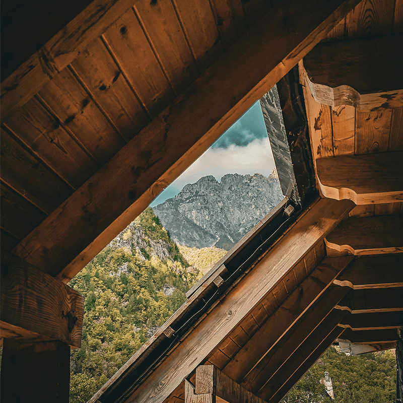 Alpine peaks framed by a cabin skylight, mountain venue for a team retreat in Europe