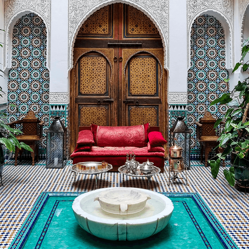 A Moroccan riad courtyard around its fountain, venue for a marketing team retreat
