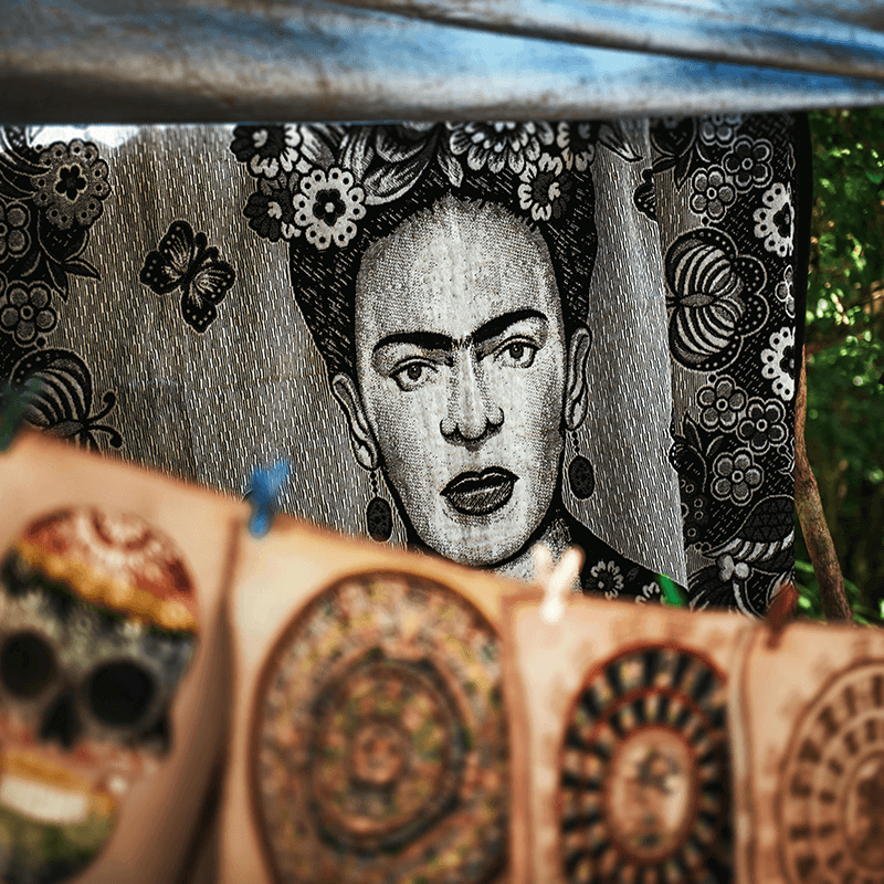 A Frida Kahlo street-art panel above the market stalls, spotted on a culture walk during a PR team retreat
