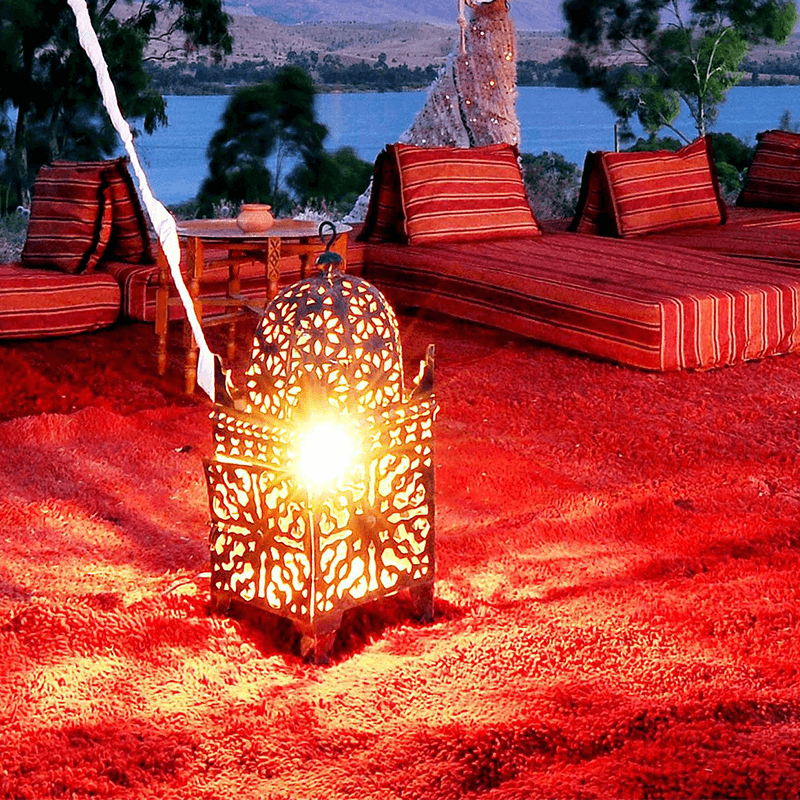 A lantern glowing on red cushions at a waterfront venue, evening of a communication team retreat