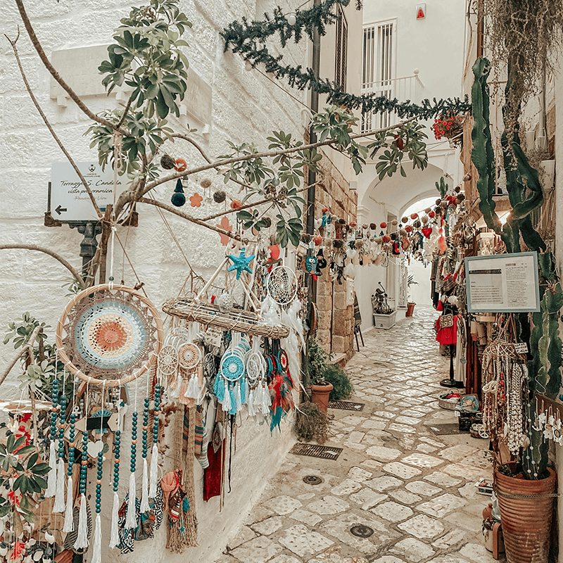 Long communal dinner table setup under tree canopy at boutique riad venue in Morocco for team retreat dining experience