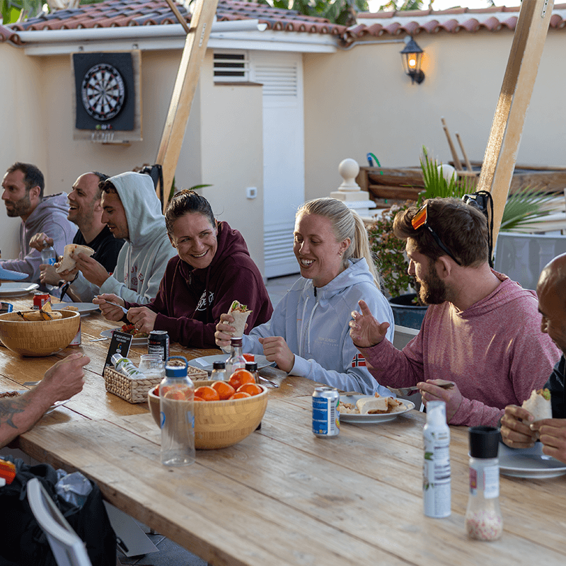 Distributed team sharing meal and conversation during company offsite bonding experience