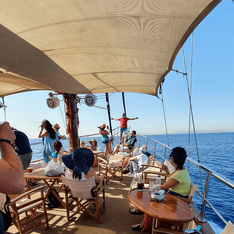 A remote team under the sunshade on deck, sailing day of a team retreat on the Mediterranean